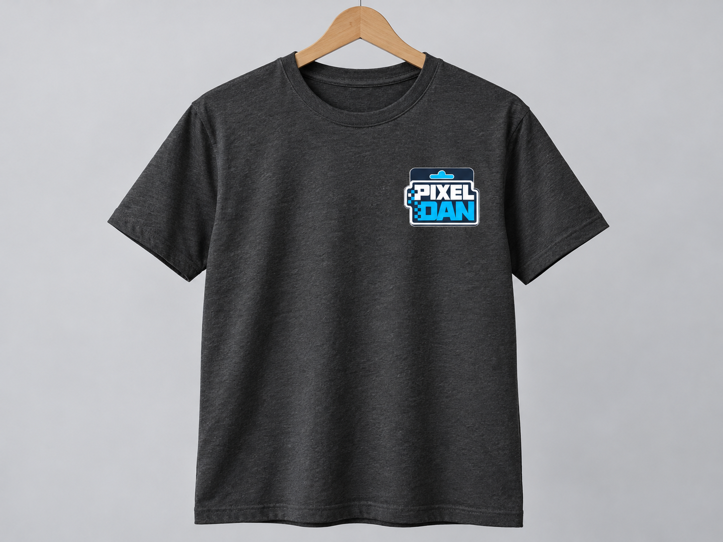 Charcoal tee with the complete Pixel Dan packaging logo printed at the left chest